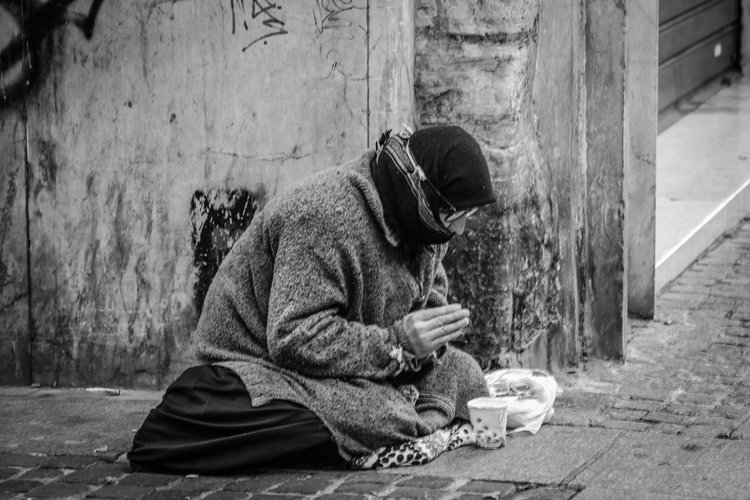 Homeless person sitting on the street