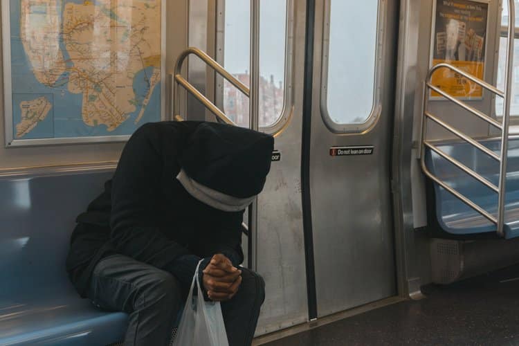 Lone man sitting inside a train